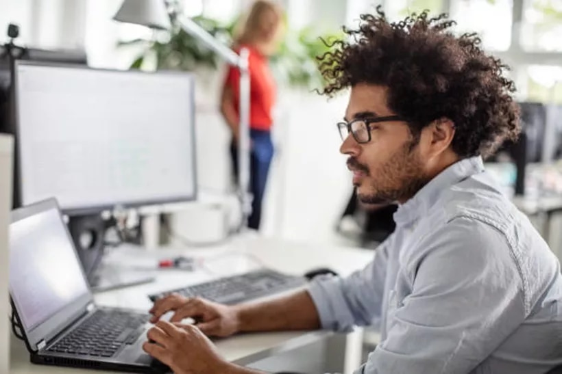 Network, collaborate, and grow — all from a Servcorp coworking space, where a man works comfortably on his laptop.