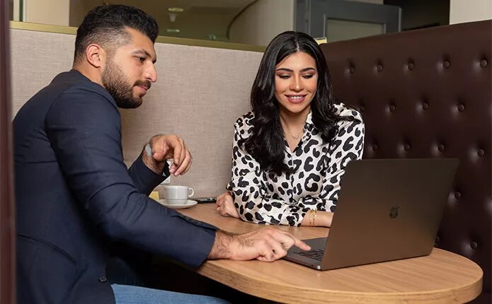 Servcorp Coworking Space with a team member supporting the client with his work.