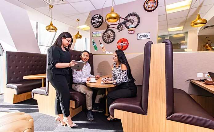 Coworking Space with people networking, collaborating, or working at dedicated desks with a luxury fit out.